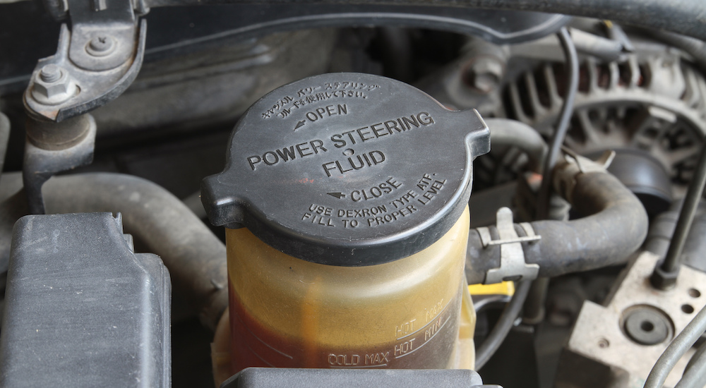 Power Steering fluid cap inside vehicle