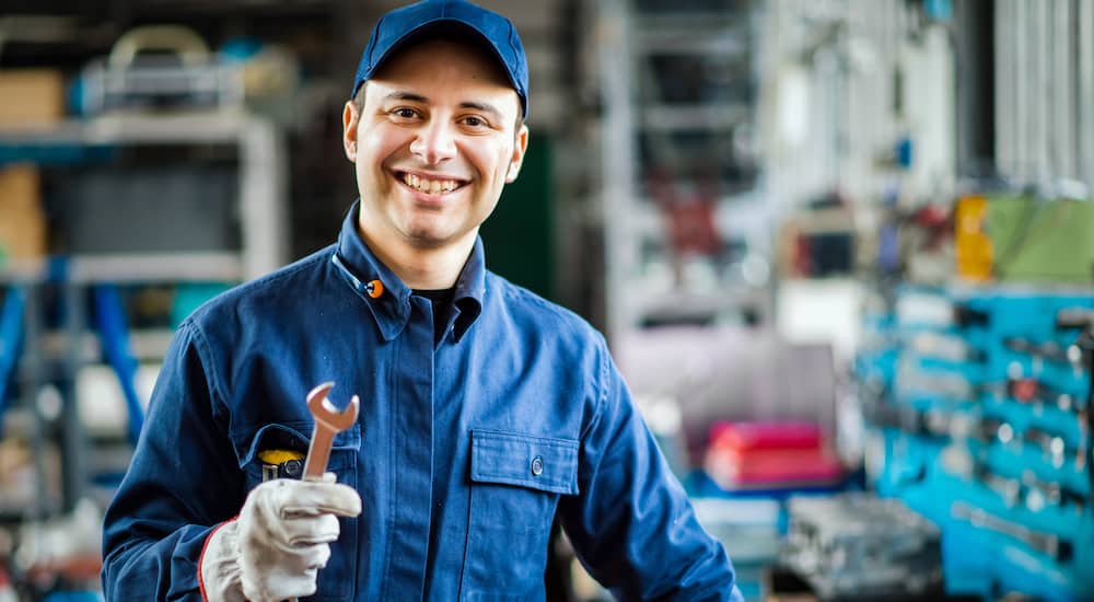 smiling mechanic in blue