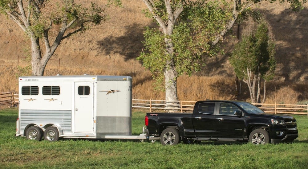 A black 2019 Chevy Colorado towing a trailer