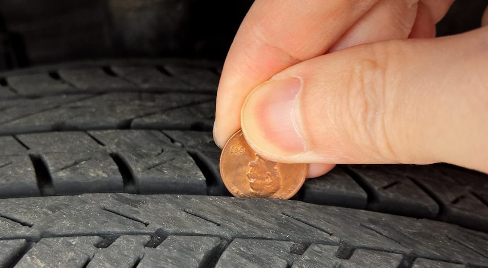 Penny being used to check tire tread depth