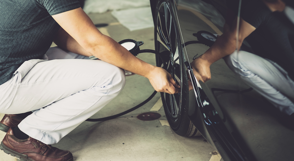 Man checking his tire pressure