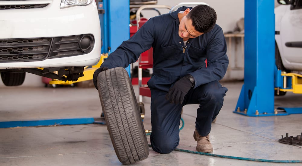 Mechanic checking tire before rotation