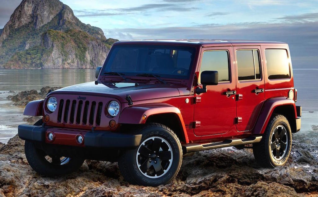Red Jeep Wrangler on the beach