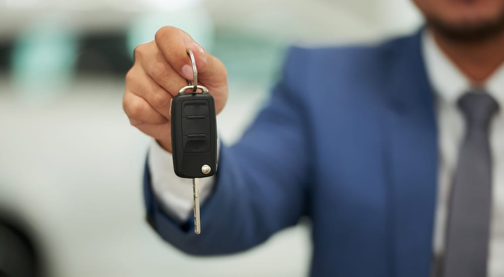 key being given to new car buyer