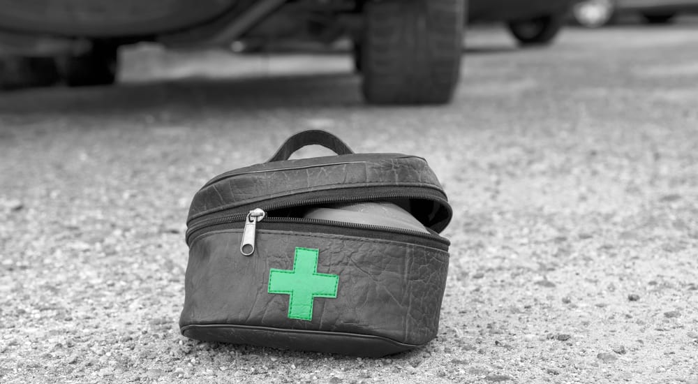 Automotive first aid kit with a car in the back