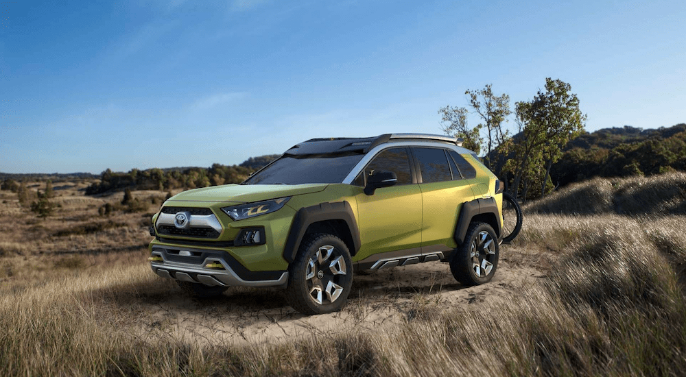 A green Toyota FT AC concept vehicle in a field