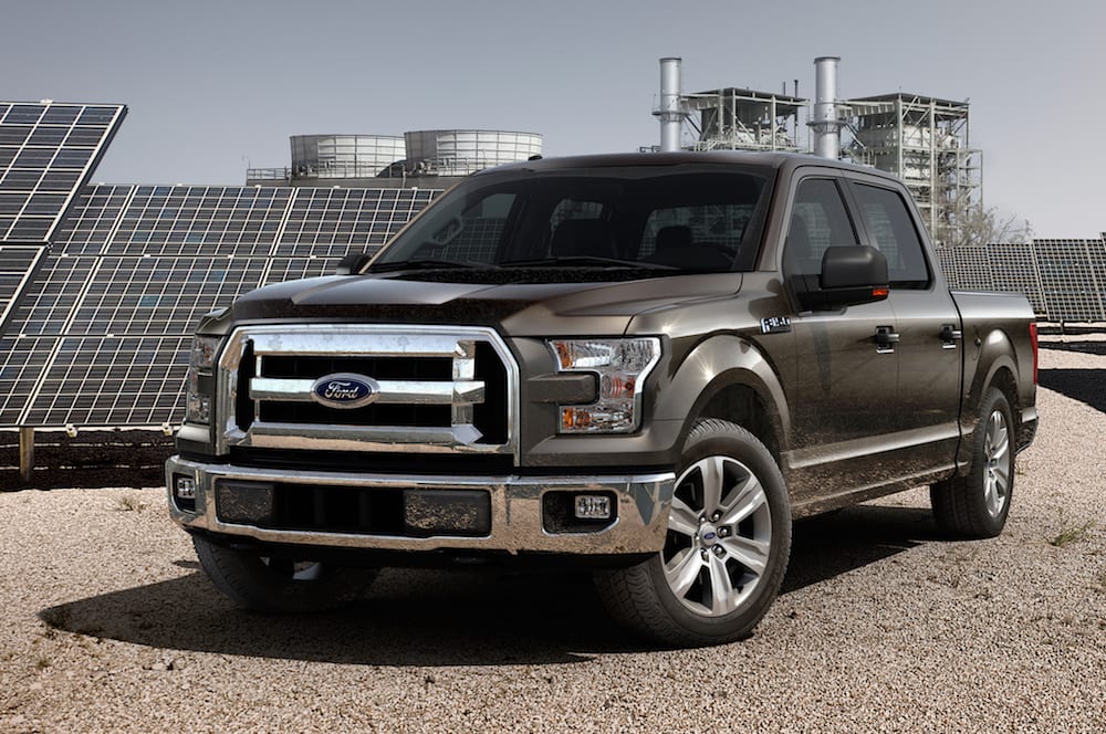 A 2015 Ford F-150 is parked in front of solar panels after leaving one of the local Ford dealers.