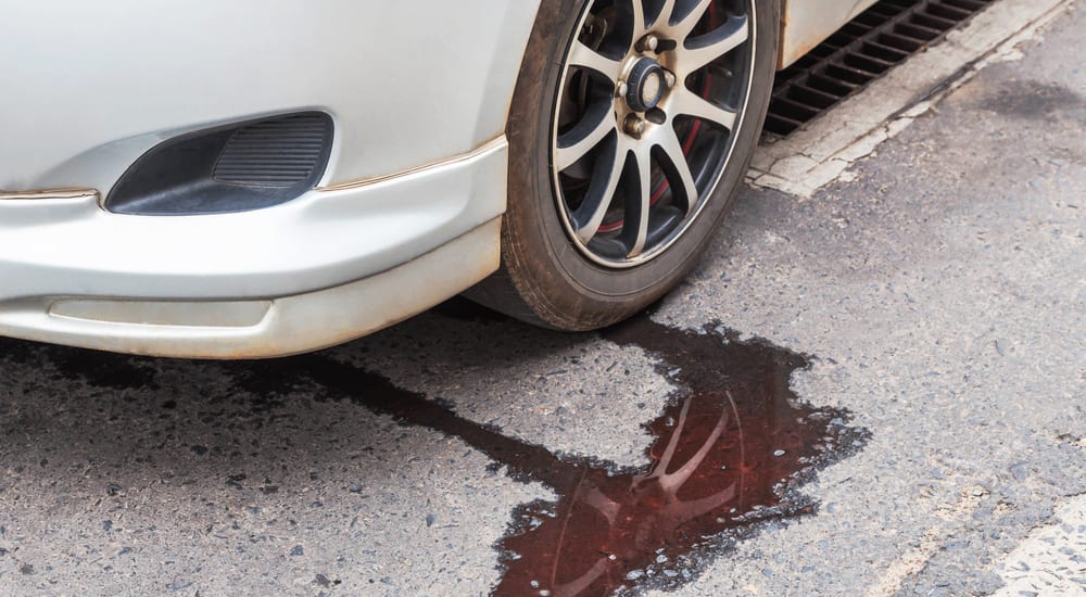 A car leaking fluid onto the road
