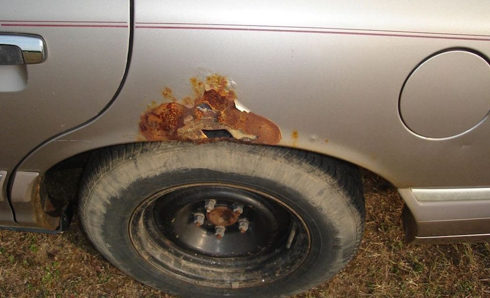 Wheel well rust on a car is shown.