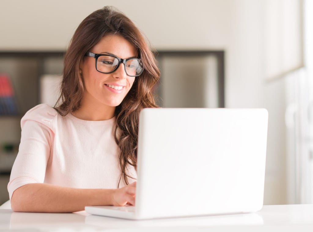 Happy Young Beautiful Woman Using Laptop, Indoors; Shutterstock ID 132478805; PO: aol; Job: production; Client: drone
