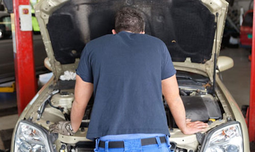 Man Looking In Engine Compartment