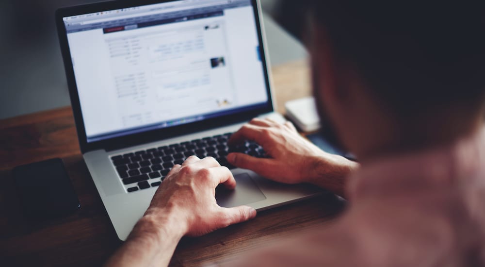 A man online shopping on a macbook pro