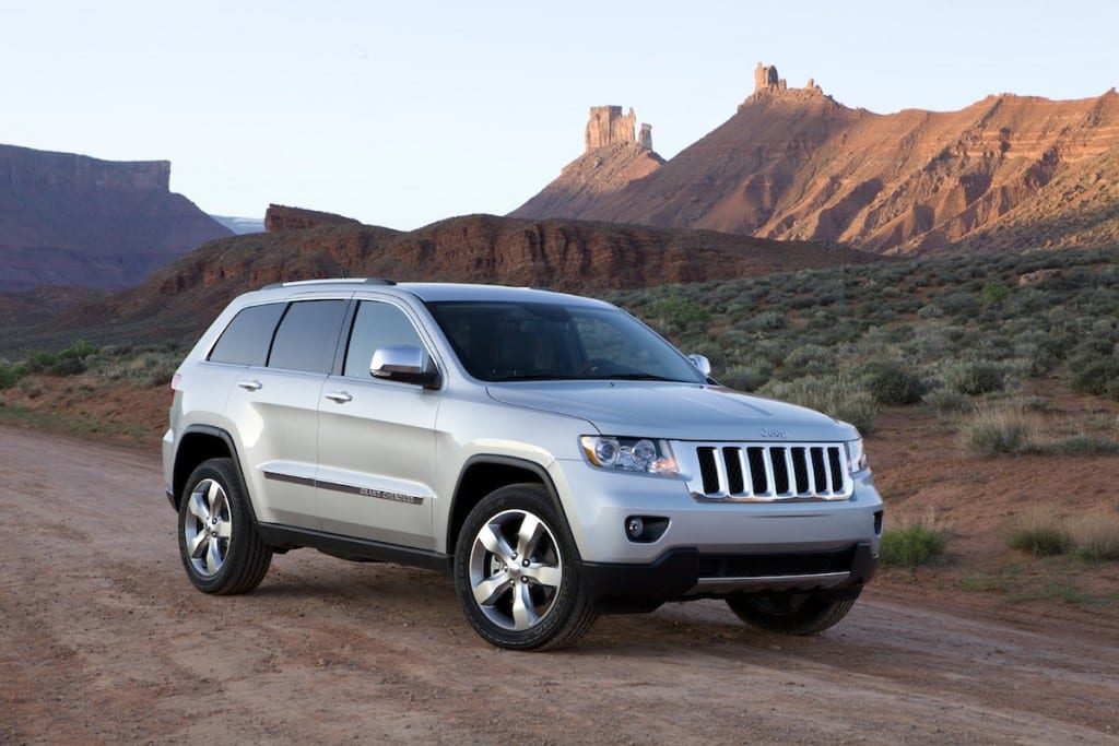 A 2011 Jeep Grand Cherokee is shown in front of the Red Rocks. A used Jeep Grand Cherokee for sale can be found at a CDJR dealer.