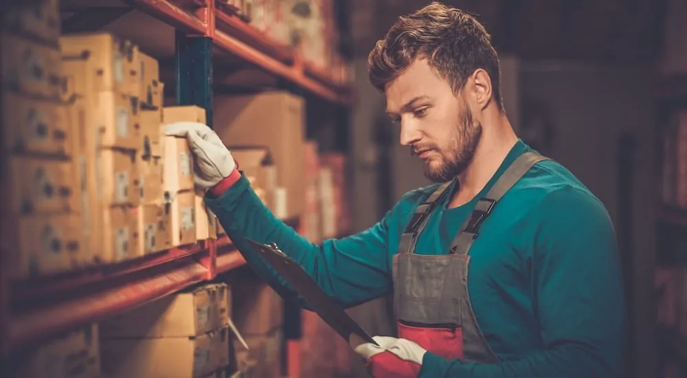 A man checking inventory in an auto parts store