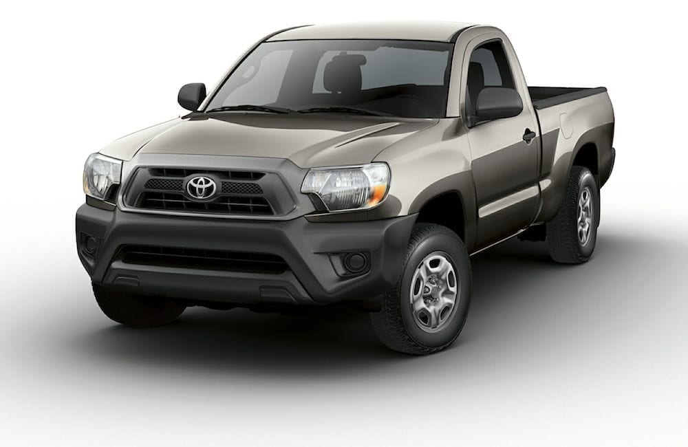 A grey 2014 Toyota Tacoma single cab is shown on a white background. You can find used truck nearby at a local Toyota dealer.