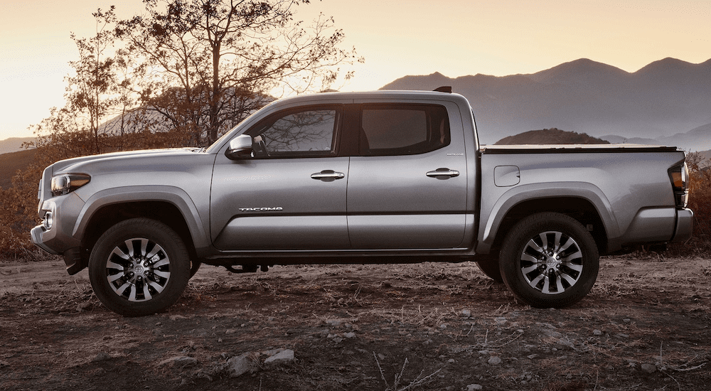 A future silver 2020 Toyota Tacoma is shown at sunset with mountains in the distance.