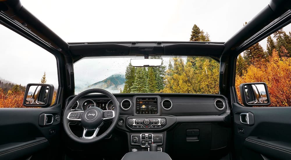 An interior view of a 2019 Jeep Wrangler, one of the popular Jeep models, is shown with the top removed.