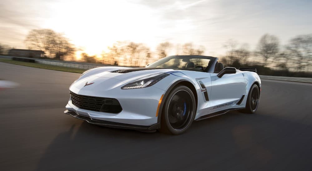 A white 2018 Chevy Corvette 65 year anniversary on a race track at sunset