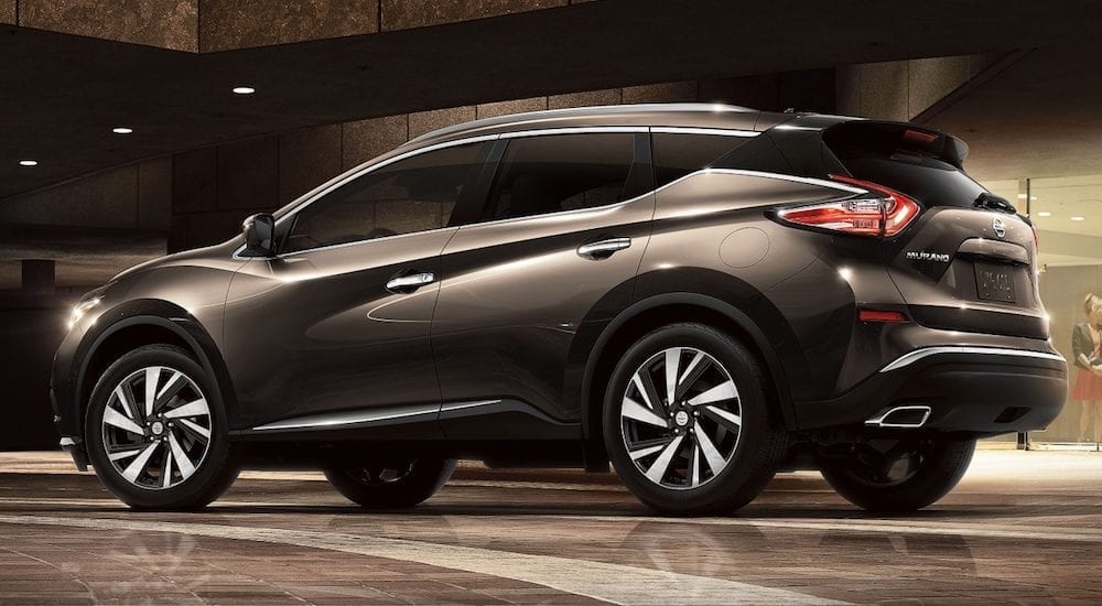 Grey 2018 Nissan Murano parked in front of brown marble building