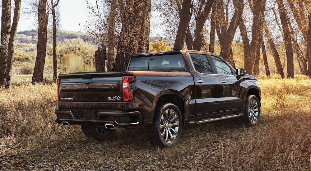 Black 2018 Chevrolet Silverado with trees and mountains in back