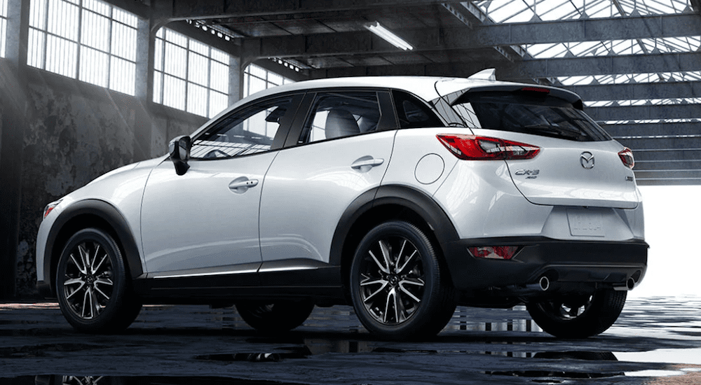 a White Mazda CX3 in a dark warehouse