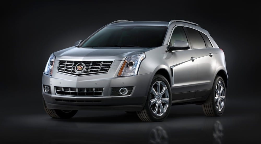 Silver 2016 Cadillac SRX on black background