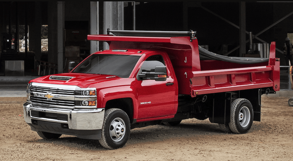 Red 2018 Chevy Silverado dump truck at construction site