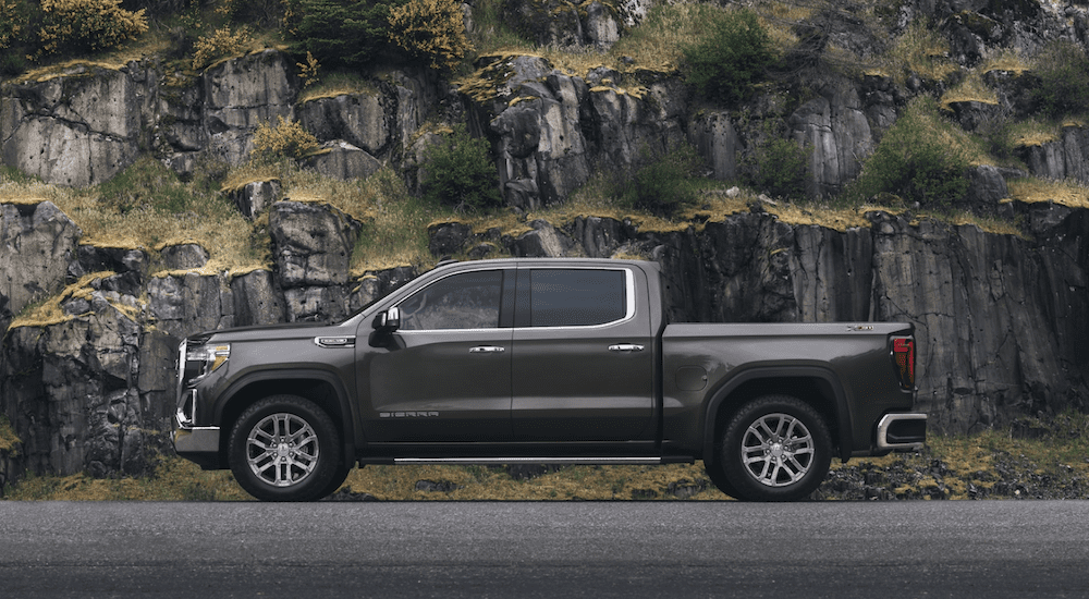 Gray 2019 GMC Sierra 1500 in front of rock cliff