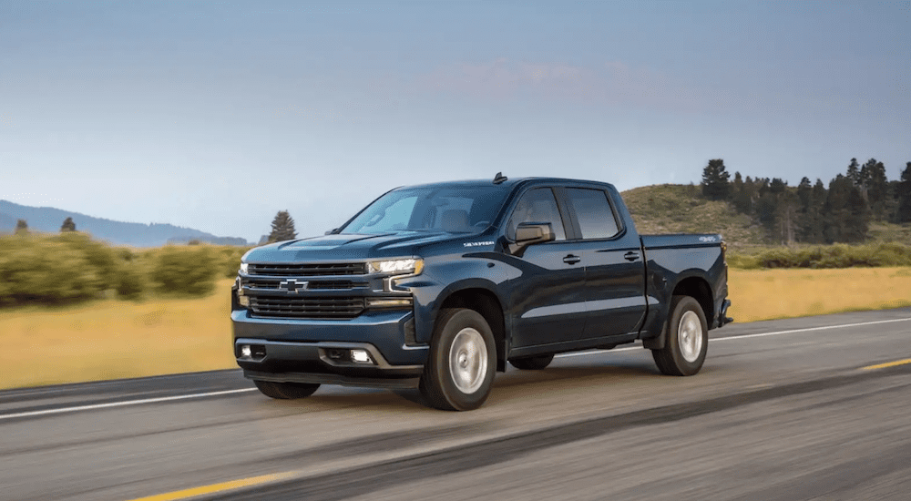 A blue 2019 Chevy Silverado 1500 goes for a test drive on the open road 