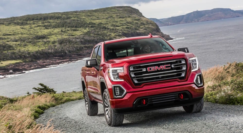 Red 2019 GMC Sierra AT4 on lake-side road