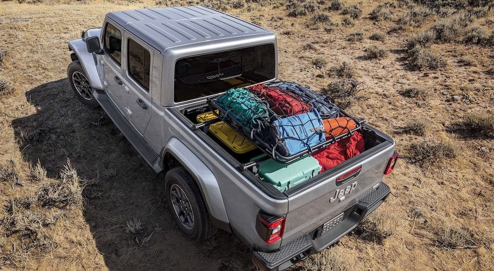 A silver 2020 Jeep Gladiator from above with its convenient bed packed pull of supplies for camping in the desert