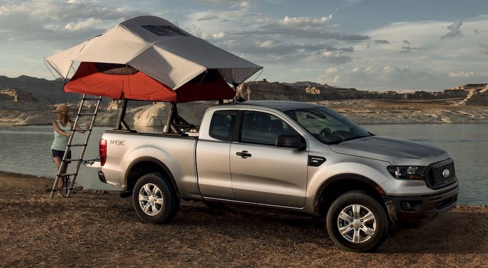 A silver 2019 Ford Ranger with a tent on the racks