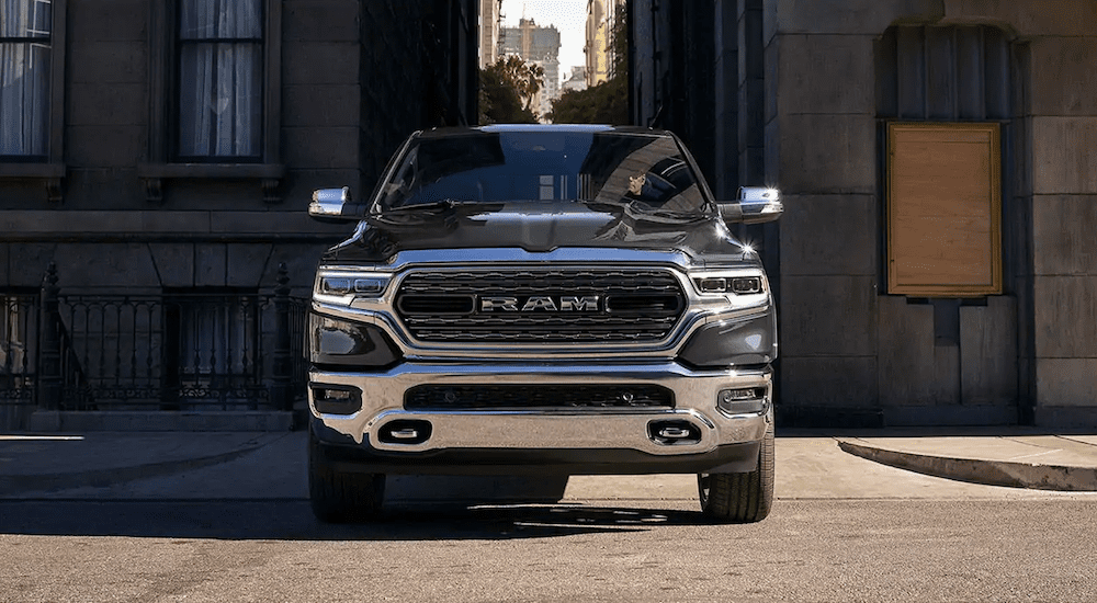 A black 2019 Ram 1500 from the front in a city alley