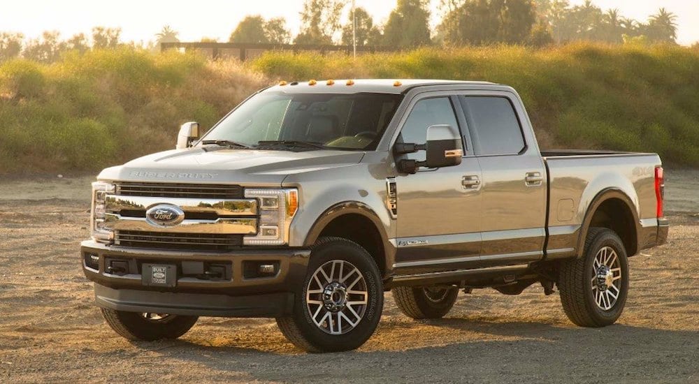 A silver 2019 Ford F-250 in a rocky sand pit