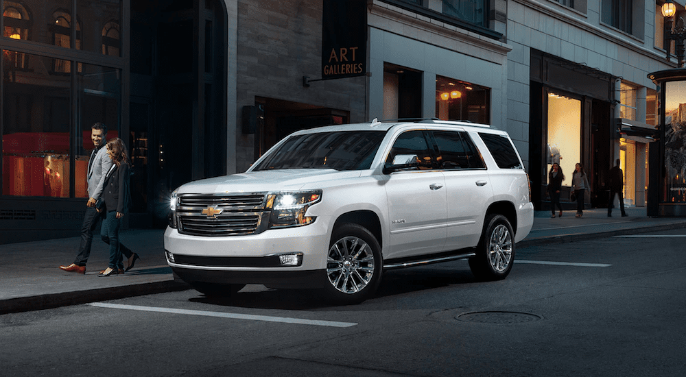 A white 2019 Chevy Tahoe parked on a city street