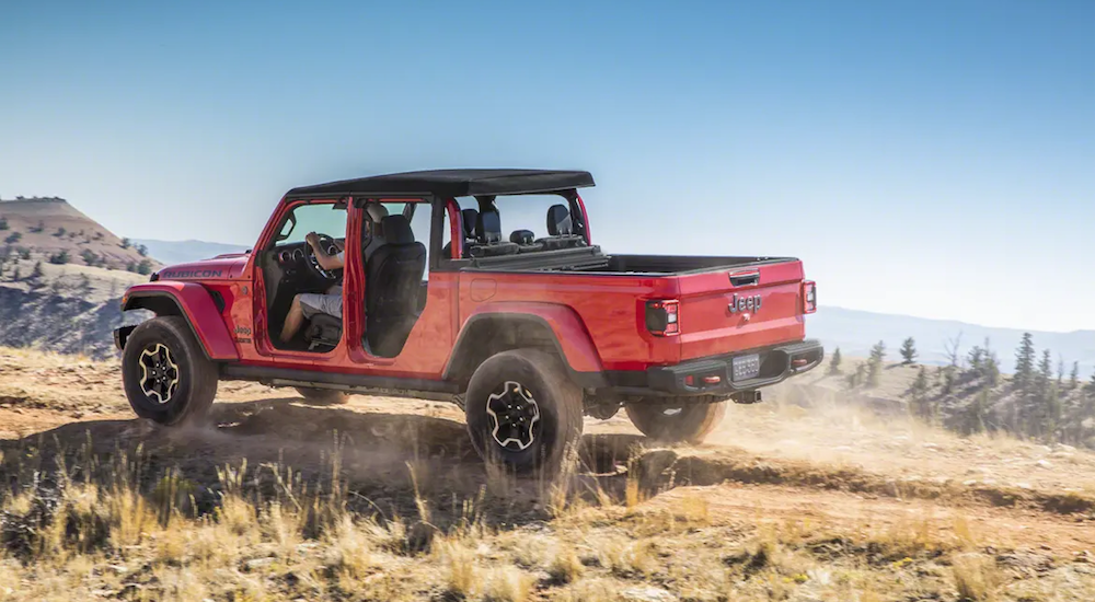 A red 2020 Jeep Gladiator off-roading with the doors off