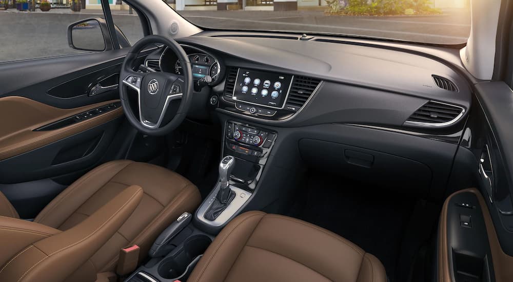 The brown and black interior of a 2019 Buick Encore is shown. The luxury interior of the Encore wins when comparing the 2019 Buick Encore vs 2019 Honda HR-V. 