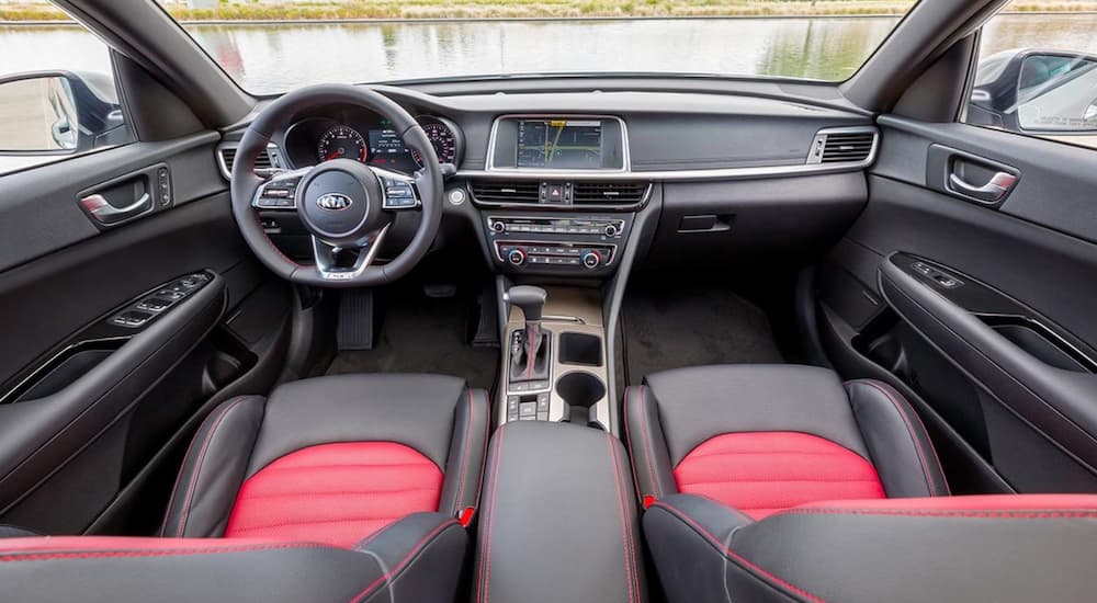 The red and black interior of the 2019 Kia Optima is shown.