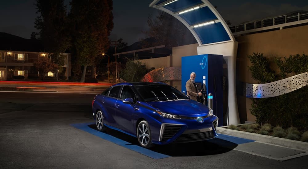 A blue 2019 Toyota Mirai is at a refueling station.