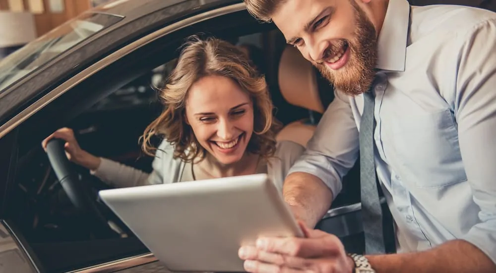 Woman smiling at the price of her new car