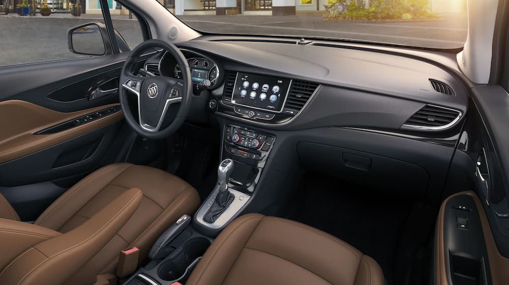 The brown and black interior of a 2019 Buick Encore is shown, which wins when comparing the 2019 Buick Encore vs 2019 Mazda CX-3.