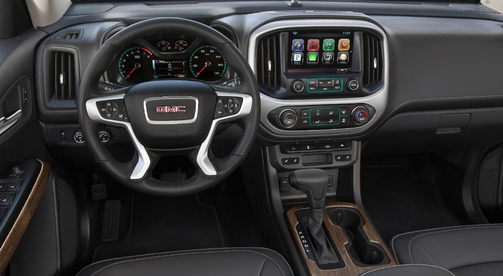The black interior of a 2019 GMC Canyon is shown, which wins when comparing the 2019 GMC Canyon vs 2019 Nissan Frontier.