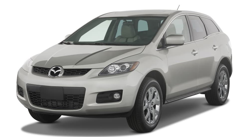 A grey 2009 Medza CX 7 SUV is parked with a white background.