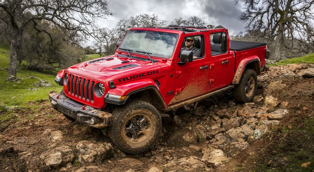 A red 2019 Jeep Gladiator is on a rocky trail.