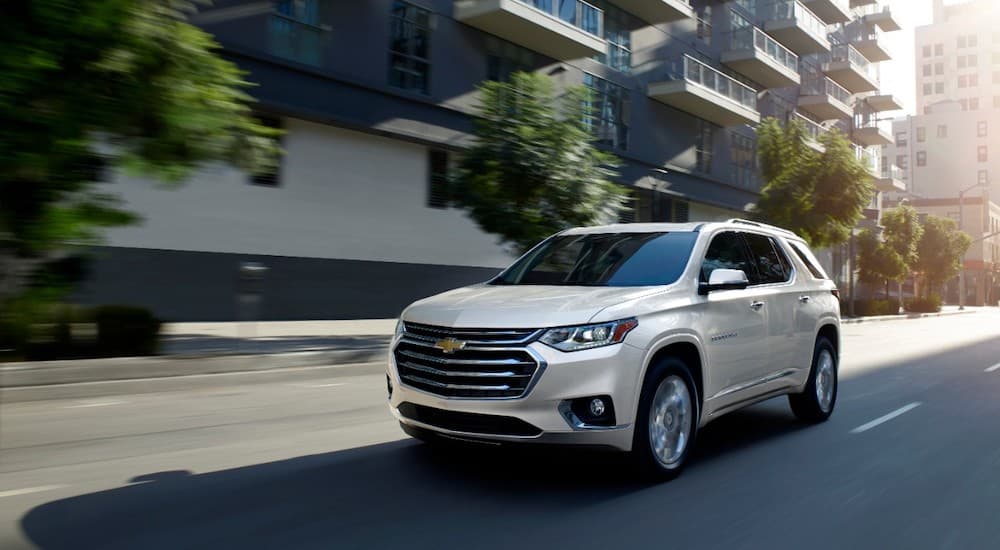 A white 2019 Chevy Traverse is driving downtown after leaving a Chevy dealer near me.