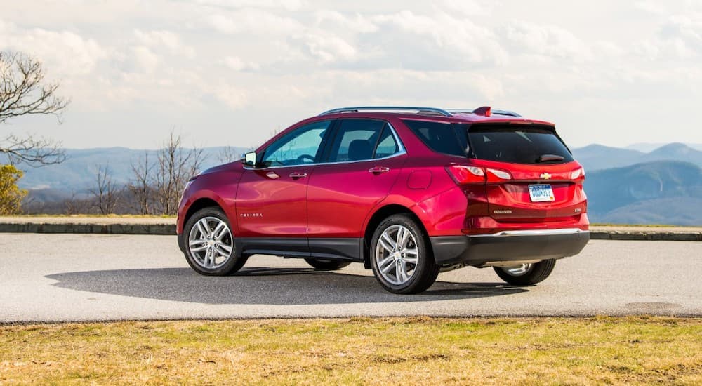 A red 2019 Chevy Equinox is parked with mountain views.