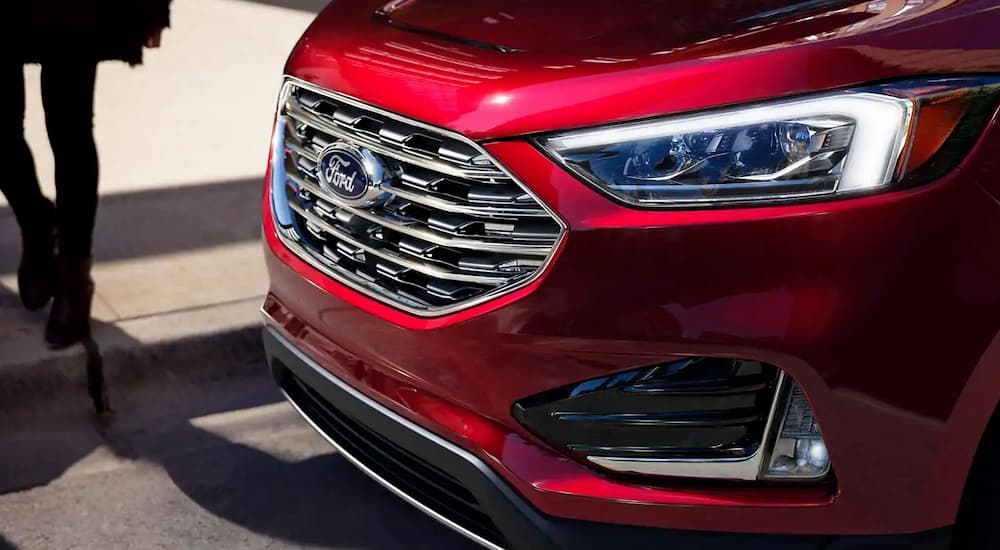 The front end of a red 2019 Ford Edge is shown, which wins when comparing the 2019 Ford Edge vs 2019 Honda Passport.