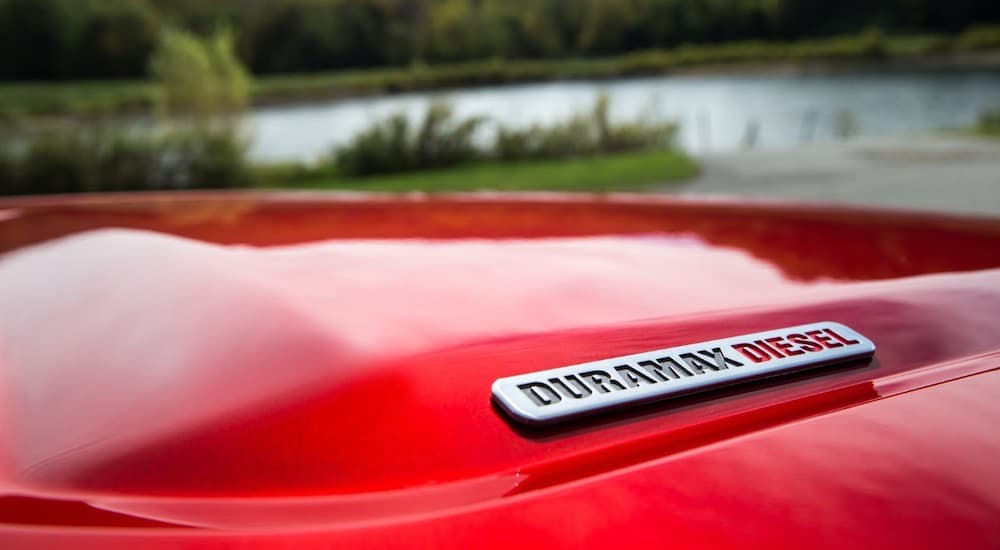 A closeup of the Duramax badge is shown on a red 2019 GMC Canyon.