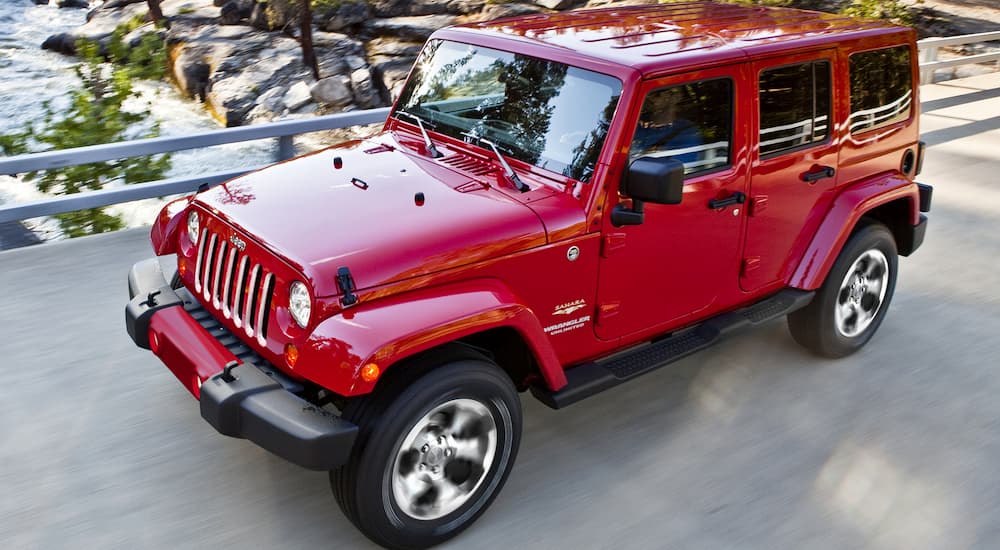 A red 2017 Jeep Wrangler is on a bridge.