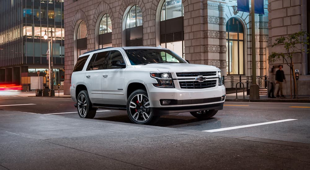 A white 2020 Chevy Tahoe is parked on a city street.